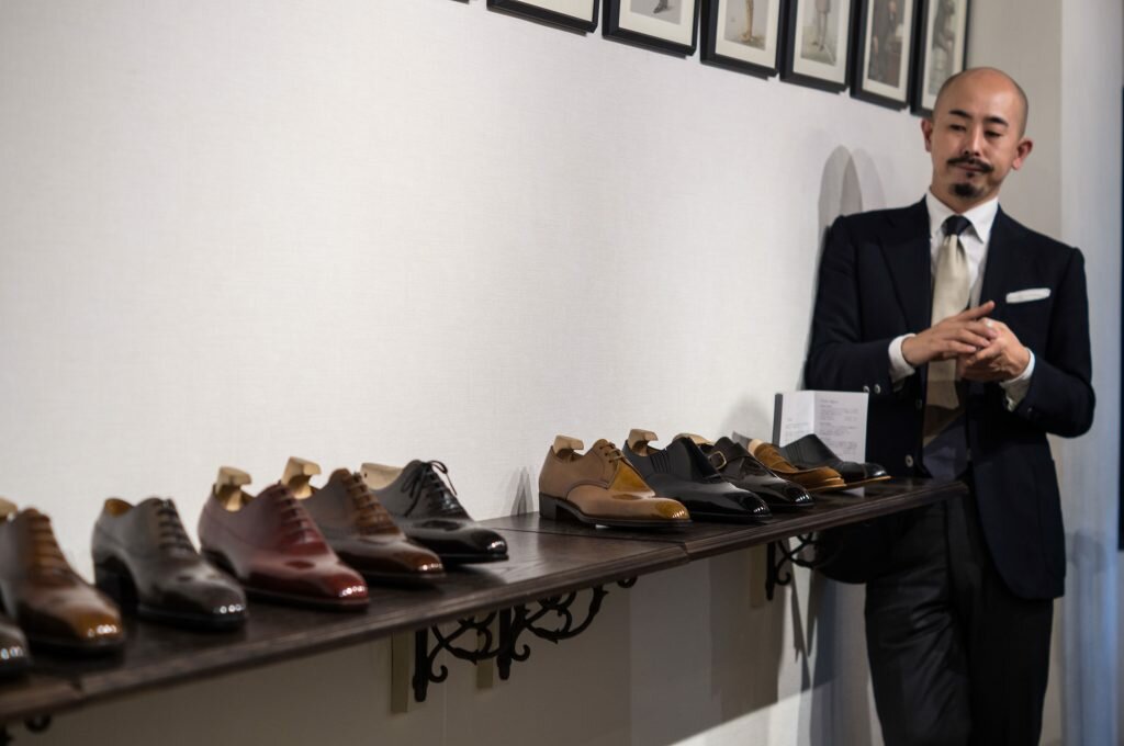 Yohei Fukuda looks at a row of his shoes